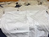 a bed that has a lot of white lace on it