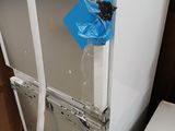a picture of a refrigerator with a blue tape on the door