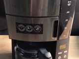 a coffee maker that is sitting on a wooden table