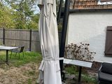 an umbrella that is sitting on a table in the yard