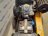 an image of a lawn mower that is being worked on