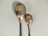 two spoons that are sitting on a table