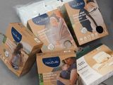 several boxes of baby products sitting on a table next to each other