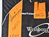 a black and orange shirt with a lot of writing on it