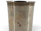 an old silver cup with a handle on a white background