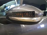 a close up of a car ' s side mirror with a speedometer