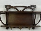 a wooden shelf that has a cat head on it