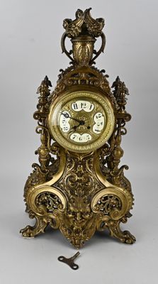 a gold clock that is sitting on a table