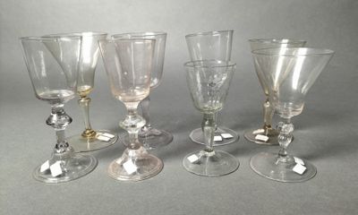 four wine glasses sitting next to each other on top of a table