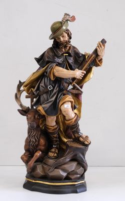 statue représentant un homme muni d'une épée et d'un chien assis sur un rocher