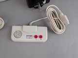 a nintendo game console with two controllers and a charger