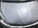 a car that has been dented and is parked in a parking lot