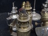 a lot of antique lamps that are sitting on a table