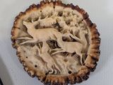 a picture of a pie with a carving of a deer in it