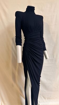 the mannequin is wearing a black dress with a high slit