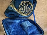 a blue case with a brass instrument inside of it