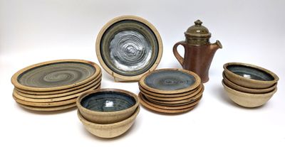 a lot of plates and cups that are sitting on a table