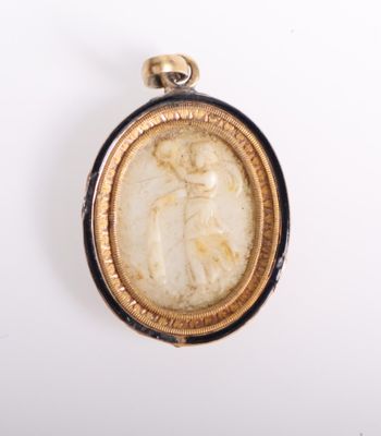 a close up of a pendant with a picture of a woman in a dress