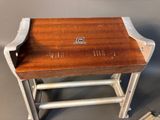 a small wooden table with a book on top of it