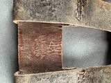 a close up of a piece of metal with a piece of wood in it