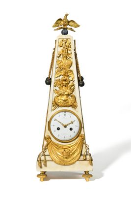 a gold clock with a bird on top of it