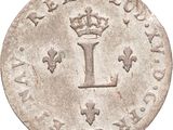 a close up of a coin with a crown on it