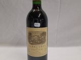 the bottle of red wine is sitting on the table