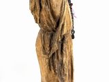 wooden statue of a woman carrying a basket on her head