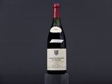 a bottle of wine sitting on top of a glass table