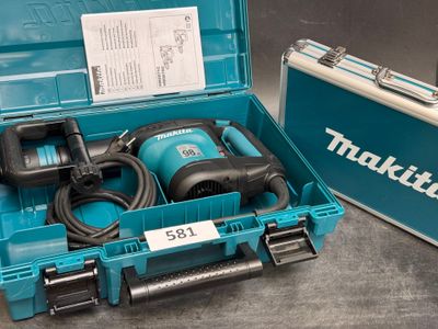 a box with a drill and a tool in it