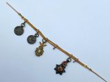 a close up of a gold bracelet with charms on it