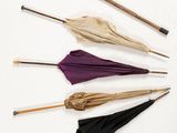 several umbrellas are arranged in a circle on a white surface