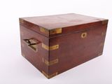a small wooden box with brass handles on a white surface