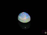 a white oplite in the dark with a black background