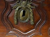 a close up of a wooden cabinet with a keyhole