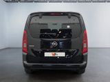 the back end of a black van parked in a garage
