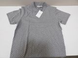 a close up of a shirt on a table with a tag on it
