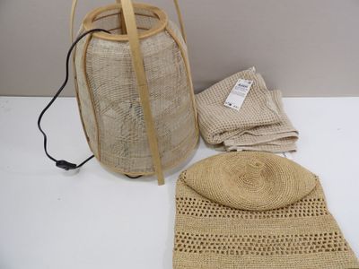 a straw bag and a straw hat on a white table