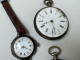 three different types of watches sitting on a table