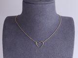 a gold heart necklace on a mannequin mannequin