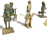 five statues of people that are standing in a row