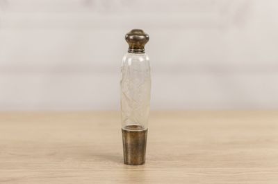 small glass bottle with a metal stopper on a wooden table