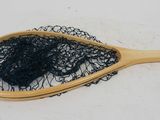 a wooden paddle with a black net on top of it