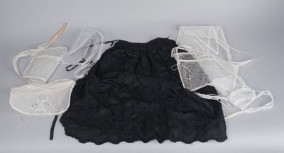 une robe noire et une paire de chaussures blanches posées sur une table
