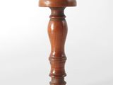 a close up of a small wooden object on a white surface