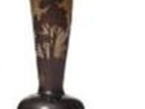 a vase with a tree on it sitting on a table