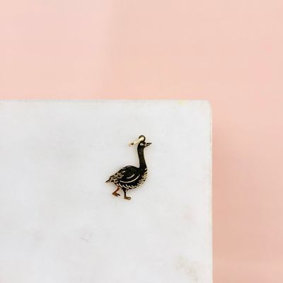 a small bird that is sitting on a marble block