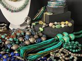 many different colored beads and necklaces on a table