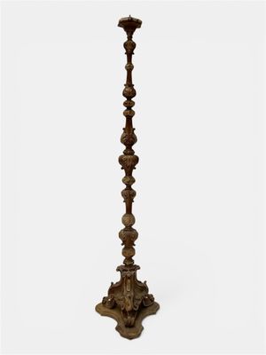 a tall wooden candle holder on a white background