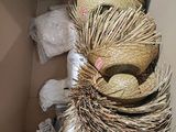 a cardboard box with a straw hat on top of it